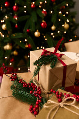 Festive Christmas decorations with beautifully wrapped gifts and a glowing tree in the background