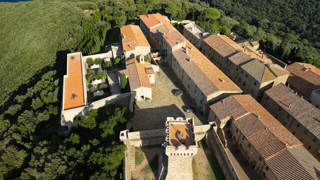Italy, landmarks of Tuscany.  Populonia ancient etruscan site and fortiefied village overlooking the sea.  Livorno province. high angle 4k aerial drone footage