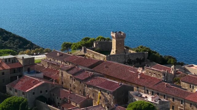 Italy, landmarks of Tuscany.  Populonia ancient etruscan site and fortiefied village overlooking the sea.  Livorno province. high angle 4k aerial drone footage