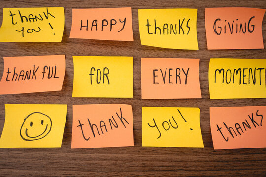 Positive and thankfull notes on a wooden background. Thanksgiving day