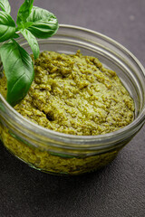 Pesto sauce basil, olive oil, parmesan, pine nuts, garlic natural product tasty snack fresh delicious gourmet food background on the table rustic top view copy space