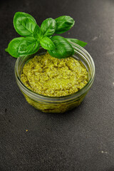 Pesto sauce basil, olive oil, parmesan, pine nuts, garlic natural product tasty snack fresh delicious gourmet food background on the table rustic top view copy space