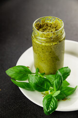 Pesto sauce basil, olive oil, parmesan, pine nuts, garlic natural product tasty snack fresh delicious gourmet food background on the table rustic top view copy space