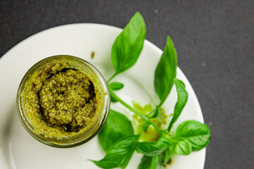 Pesto sauce basil, olive oil, parmesan, pine nuts, garlic natural product tasty snack fresh delicious gourmet food background on the table rustic top view copy space