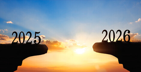 Silhouette of happy new year 2026 and 2027 on sunset background