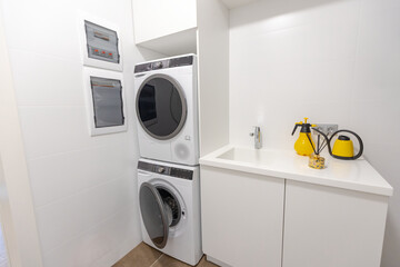 Interior of laundry room with washing machines and dirty clothes