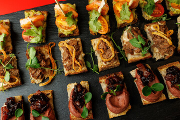 Assorted canapes with shrimp, tomato, and meat toppings