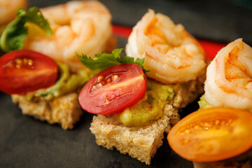 Shrimp canape with guacamole and cherry tomato