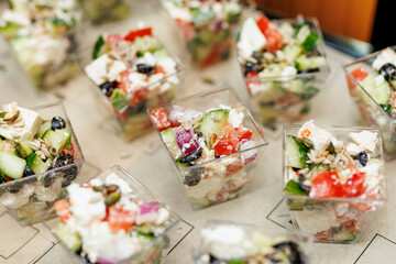 Mini greek salad portions in transparent cups