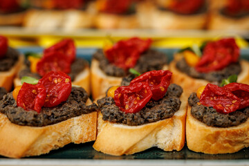 Bruschetta with black olive paste and dried tomatoes