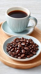 Fototapeta premium A Beautifully Styled Flat Lay of Rich Roasted Coffee Beans in a Blue Dish Next to a Cup of Dark Hot Coffee on a Wooden Tray with a Light Textured Background