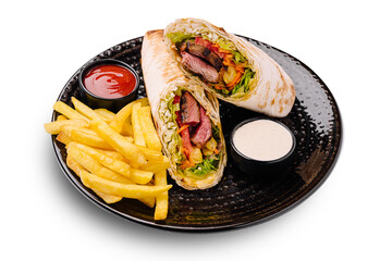 Delicious wrap with grilled meat and fries served on a black plate