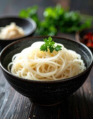 Close Up Shot of Asian Noodles in Black Ceramic Bowl with Parsley Garnish on Wooden Surface