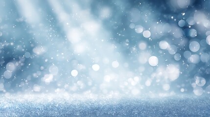 Fototapeta premium Abstract blue winter background with snow and glitter lights for christmas card
