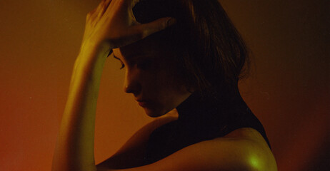 moody neon women portrait with creative lights and dramatic shadows