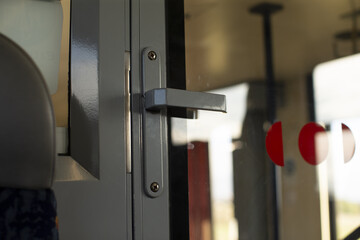 Closeup of vehicle lock, Close examination of public transportation door latch and transparent panel