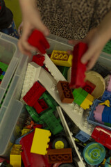 Students engage in sorting and exploring colorful plastic blocks within lively educational environment