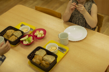 Children enjoy meal, Young children dine calmly indoors together, Two youngsters at table with plates