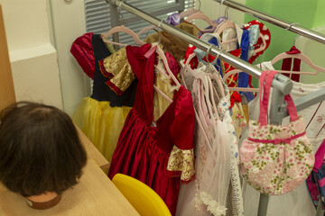 Bright outfits for kids ready for performance, Colorful garments and dresses in lively playroom setting