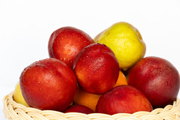 Fresh Nectarines and Pears in Basket. Mixed Fruits with Water Droplets on White Background
