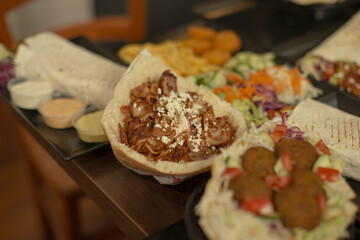 A colorful platter of traditional Middle Eastern foods like pita, falafel, and salad, ideal for sharing