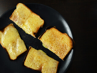 Cheese on toast on a plate.