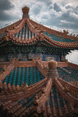 Naklejka premium Close up view of an ancient building in Beijing, China, at the Summer Palace. The architecture displays intricate details under a cloudy sky.