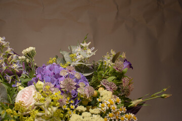 Bouquet of flowers placed on a dark gray background, showing decorative floral arrangement as part of cultural tradition and aesthetic presentation.