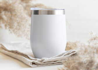 White stainless steel 12oz tumbler on linen near pampas grass Closeup, mockup for print on demand