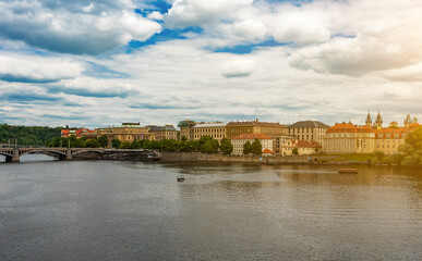 Obraz premium Prague River View Historic Buildings Sun Flare Effect.
