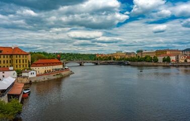 Fototapeta premium Vltava River Flowing Through Historic Prague Cityscape.