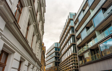 Architectural Contrast Old Facade Beside Modern Building.