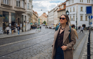 Stylish Woman on Cobblestone Street in European City.