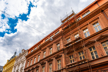 Building Facade Covered with Construction Scaffoldings.