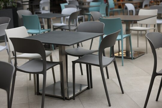 Food court with clean chairs and tables in shopping mall