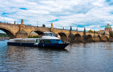 Tourist Cruiser Passing Historic Charles Bridge on Vltava.