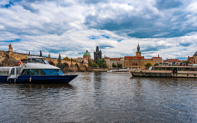 Tourist Cruiser Passing Historic Charles Bridge on Vltava.