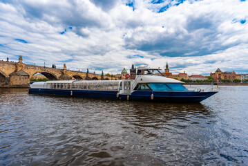 Tourist Cruiser Passing Historic Charles Bridge on Vltava.