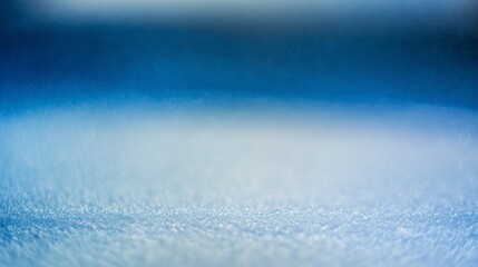 Macro shot of frosty snow surface with soft focus and blue lighting. Minimal winter background with empty space, perfect for seasonal banners, product mockups, or clean design layouts.