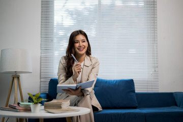 Professional woman thinking, brainstorming ideas, writing in notebook