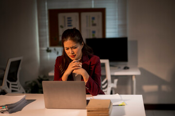 Stressed businesswoman working late at office, feeling overwhelmed