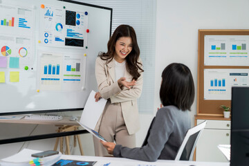 Happy businesswomen discussing marketing strategy during office meeting