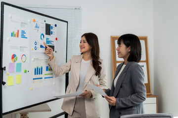 Businesswomen discussing data analysis during office meeting
