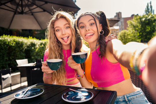 Funny sunlit selfie with best friends at a stylish outdoor cafe showing joy friendship travel vibes and youth energy - Powered by Adobe