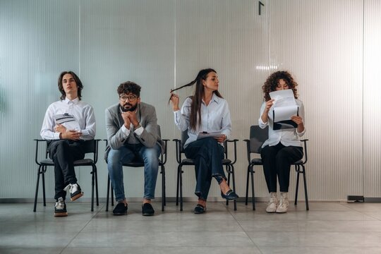 Potential workers. People near the wall, waiting for a job interview