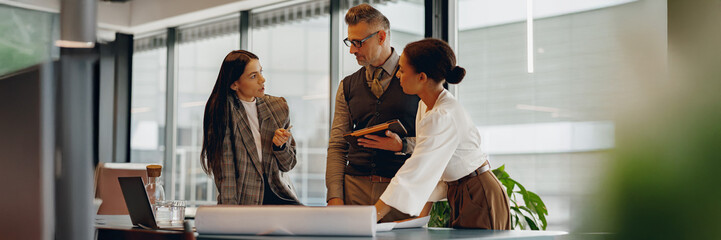 A diverse group of professionals actively participating in discussion and collaboration at a modern...