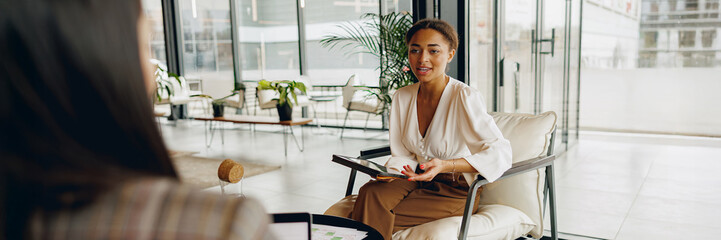 Two experienced professionals engage in a lively and dynamic business discussion within a modern workspace