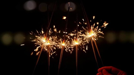 Captivating image of sparklers glowing in the dark, perfect for celebrations, parties, and festive occasions
