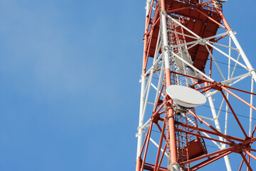 A tall telecommunication tower with antennas reaching into the clear blue sky. Ideal for technology and communication themes.