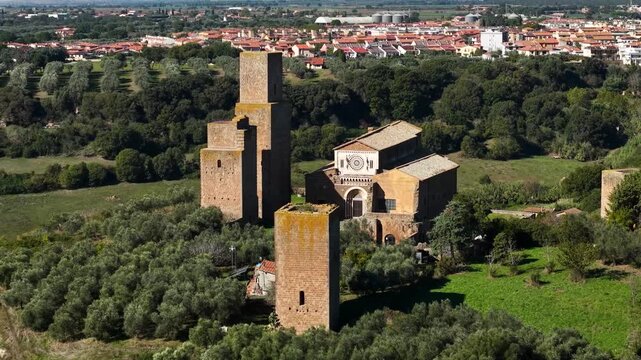 Italy, Viterbo province. Italian historic landmarks and archeological sites. ancient Etruscan city of Tuscania, Tuscia. view of San Pietro e Santa Maria Maggiore church. aerial drone 4k hd footage